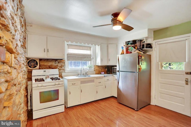 30 N Dwight St, Reading, PA 19609 - kitchen with freestanding refrigerator, white gas range, light wood-style flooring, and ceiling fan