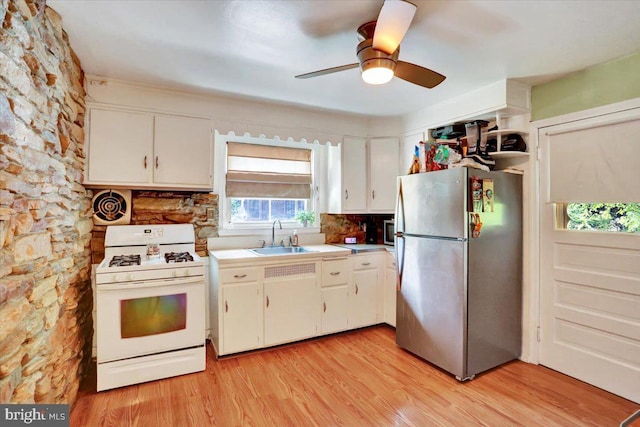 30 N Dwight St, Reading, PA 19609 - kitchen featuring freestanding refrigerator, white gas range oven, white cabinetry, and light wood-style flooring