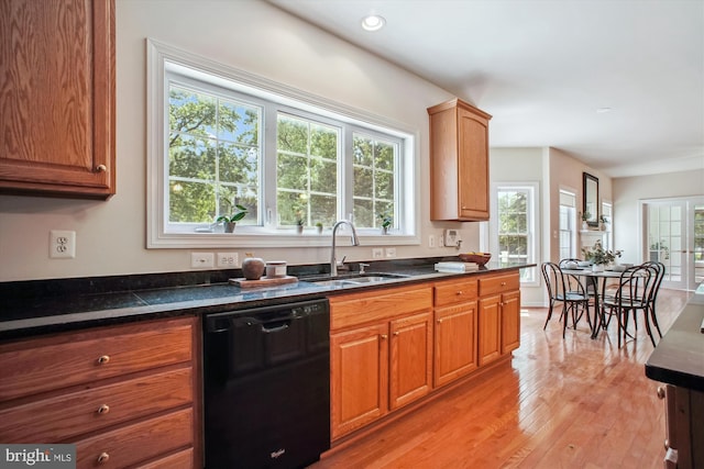 2907 Dumas St, Alexandria, VA 22306 - kitchen with black dishwasher, light wood finished floors, dark countertops, and brown cabinets