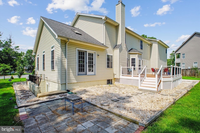 2907 Dumas St, Alexandria, VA 22306 - rear view of house featuring a chimney, a patio area, and a deck