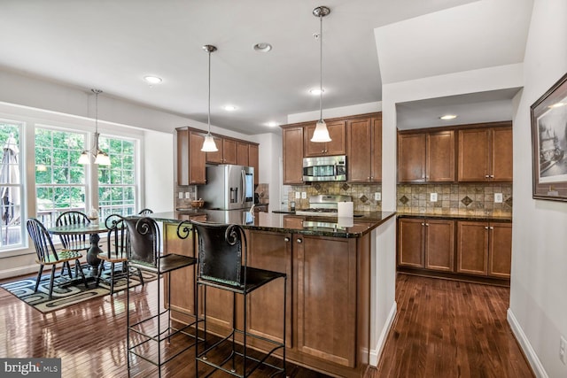 1413 Triton Ct, Edgewater, MD 21037 - kitchen with stainless steel appliances, dark wood-style floors, brown cabinetry, backsplash, and recessed lighting