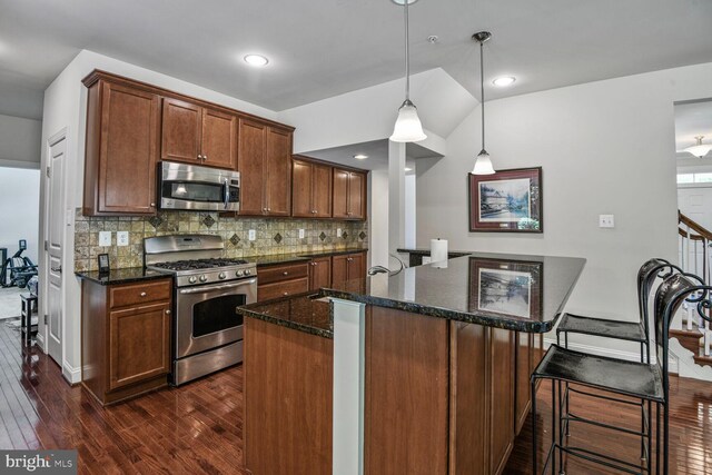 1413 Triton Ct, Edgewater, MD 21037 - kitchen featuring stainless steel appliances, dark wood finished floors, dark stone counters, tasteful backsplash, and recessed lighting