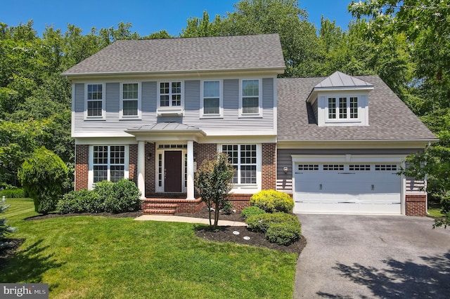1413 Triton Ct, Edgewater, MD 21037 - colonial house with brick siding, driveway, a front yard, and a garage