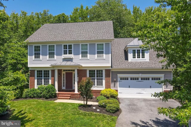 1413 Triton Ct, Edgewater, MD 21037 - colonial house with driveway, brick siding, a front yard, and roof with shingles