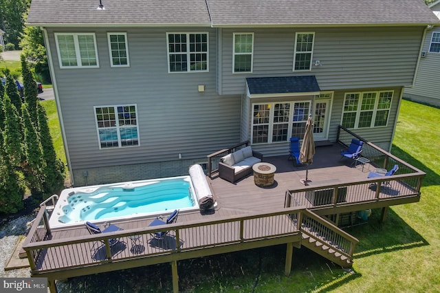 1413 Triton Ct, Edgewater, MD 21037 - rear view of property featuring a deck, an outdoor hot tub, a shingled roof, and a yard