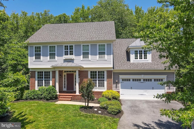1413 Triton Ct, Edgewater, MD 21037 - colonial house with driveway, brick siding, a front yard, and roof with shingles