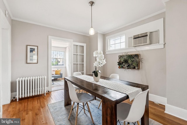 1818 Newton St NE, Washington, DC 20018 - dining space featuring radiator, crown molding, wood finished floors, and an AC wall unit