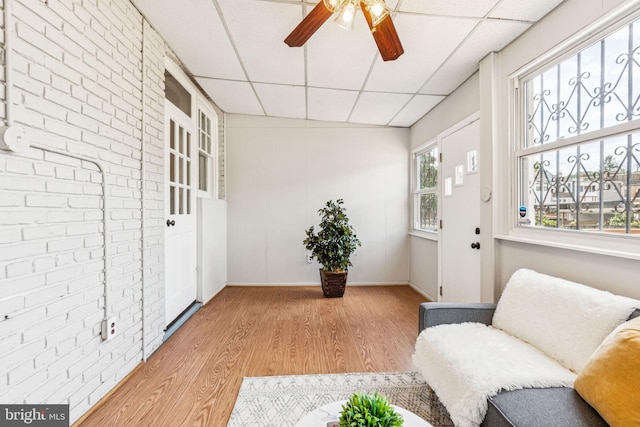 1818 Newton St NE, Washington, DC 20018 - living area with a paneled ceiling, light wood-style flooring, ceiling fan, and brick wall