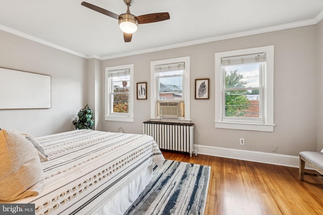 1818 Newton St NE, Washington, DC 20018 - bedroom featuring radiator heating unit, multiple windows, hardwood / wood-style floors, ornamental molding, and ceiling fan