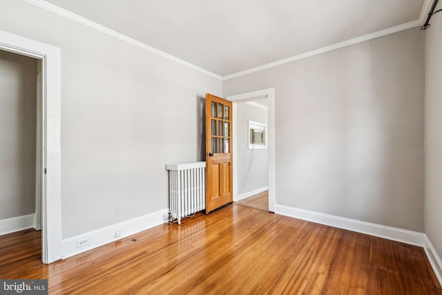 1818 Newton St NE, Washington, DC 20018 - spare room featuring wood finished floors, crown molding, and radiator heating unit
