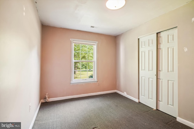 14050 Oaks Rd, Hughesville, MD 20637 - unfurnished bedroom with dark carpet and a closet