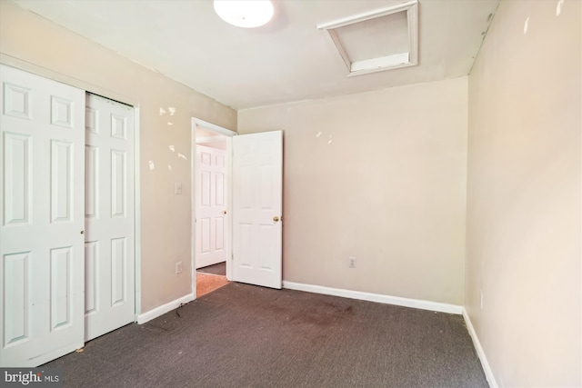 14050 Oaks Rd, Hughesville, MD 20637 - unfurnished bedroom with dark carpet, attic access, and a closet