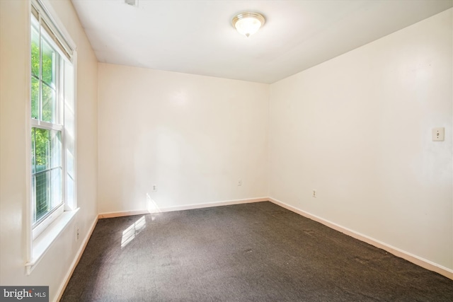14050 Oaks Rd, Hughesville, MD 20637 - unfurnished room featuring dark colored carpet and baseboards