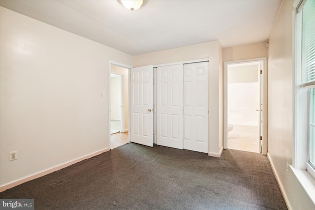 14050 Oaks Rd, Hughesville, MD 20637 - unfurnished bedroom with dark carpet and a closet