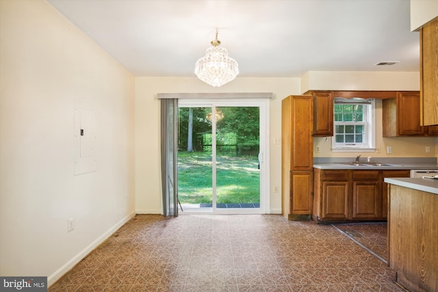 14050 Oaks Rd, Hughesville, MD 20637 - kitchen featuring brown cabinetry, a chandelier, and hanging light fixtures