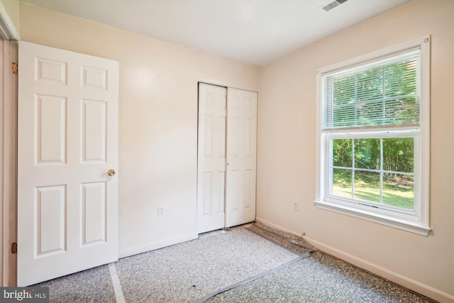 14050 Oaks Rd, Hughesville, MD 20637 - unfurnished bedroom featuring a closet and speckle patterned floor