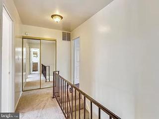 5005 Berwyn Rd, College Park, MD 20740 - hallway featuring an upstairs landing and light colored carpet