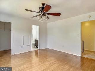 5005 Berwyn Rd, College Park, MD 20740 - unfurnished bedroom with a spacious closet, wood finished floors, a closet, ensuite bath, and a ceiling fan