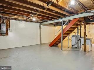 5005 Berwyn Rd, College Park, MD 20740 - unfinished below grade area featuring electric panel, stairs, and washer / clothes dryer