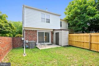 5005 Berwyn Rd, College Park, MD 20740 - rear view of house featuring a fenced backyard, brick siding, and a patio area