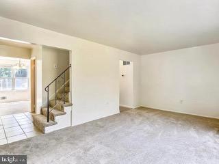 5005 Berwyn Rd, College Park, MD 20740 - carpeted spare room with stairway