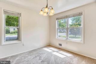 5005 Berwyn Rd, College Park, MD 20740 - carpeted empty room featuring a chandelier and baseboards