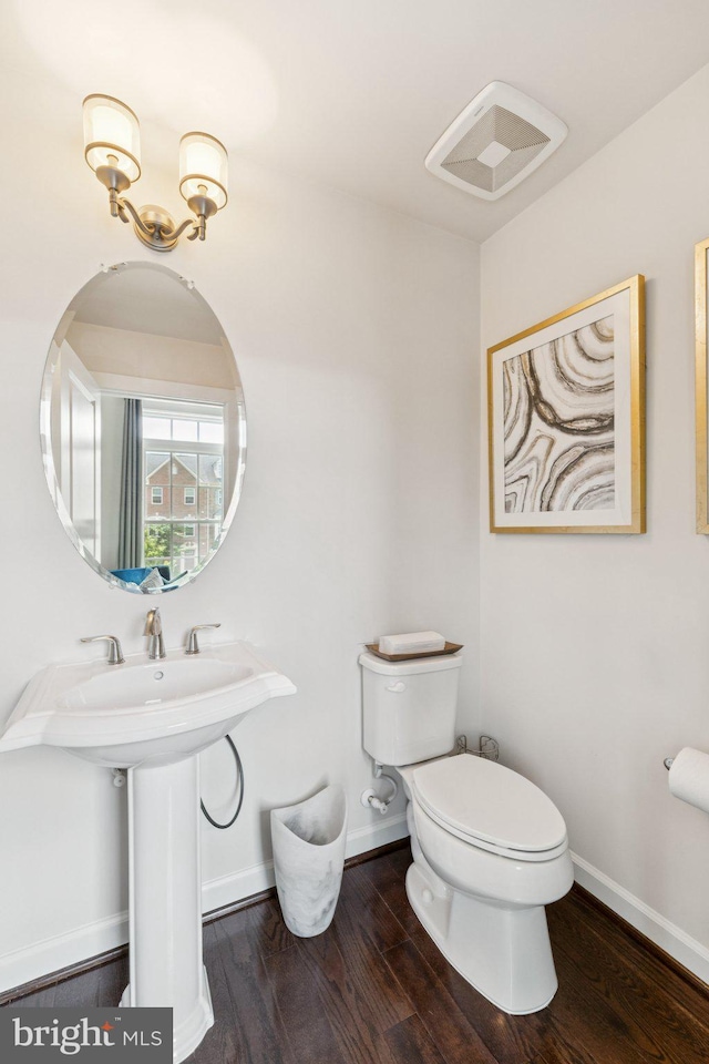 5445 Stream Bank Ln, Greenbelt, MD 20770 - half bath featuring toilet and wood finished floors
