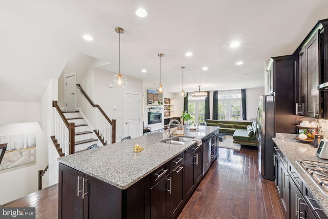 5445 Stream Bank Ln, Greenbelt, MD 20770 - kitchen with open floor plan, freestanding refrigerator, light stone countertops, recessed lighting, and a center island with sink