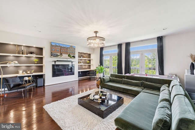 5445 Stream Bank Ln, Greenbelt, MD 20770 - living area with wood-type flooring, a chandelier, built in features, and a glass covered fireplace