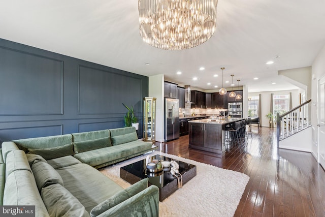 5445 Stream Bank Ln, Greenbelt, MD 20770 - living room with dark wood finished floors, a chandelier, recessed lighting, and stairway