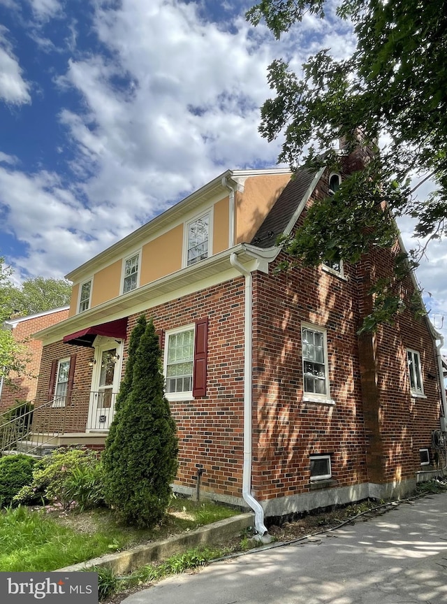 257 Jefferson St, Winchester, VA 22601 - view of side of home featuring brick siding and covered porch