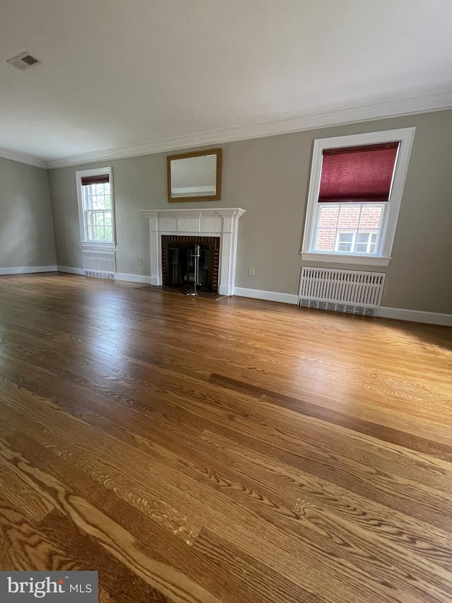 257 Jefferson St, Winchester, VA 22601 - unfurnished living room with radiator, ornamental molding, wood finished floors, and a fireplace