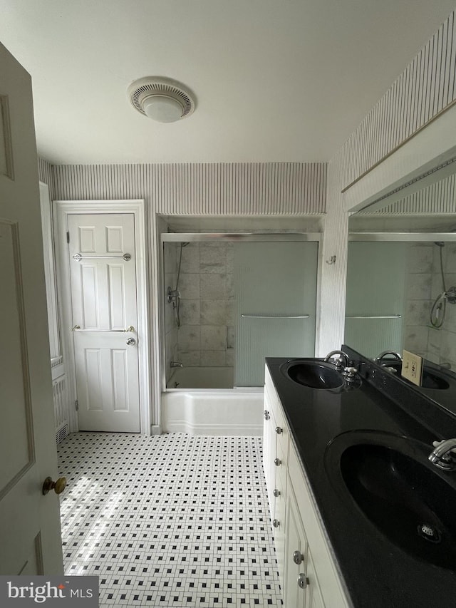 257 Jefferson St, Winchester, VA 22601 - full bath with combined bath / shower with glass door, double vanity, and tile patterned floors