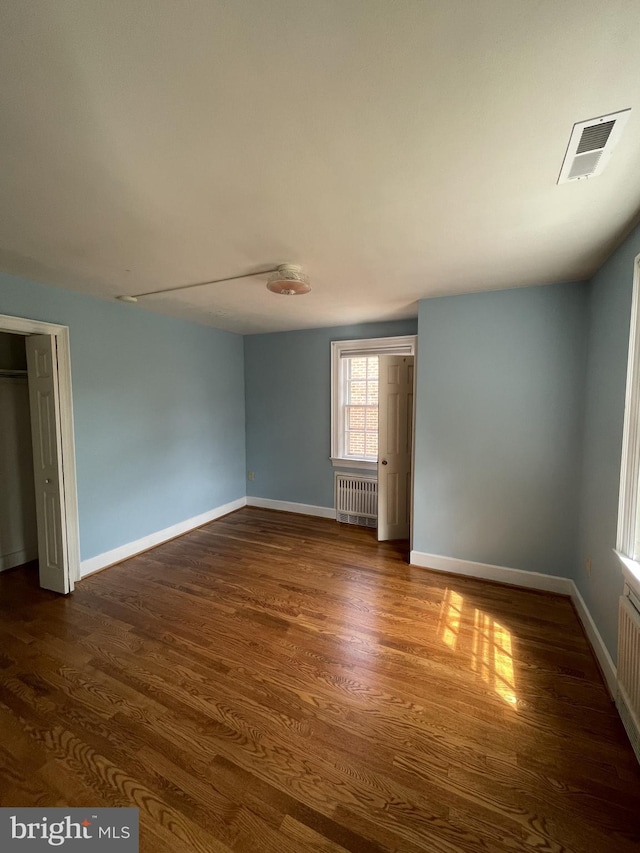 257 Jefferson St, Winchester, VA 22601 - unfurnished room featuring radiator and dark wood-style floors