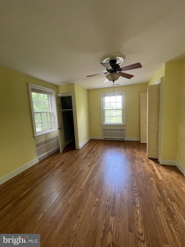 257 Jefferson St, Winchester, VA 22601 - unfurnished living room with radiator heating unit, wood finished floors, and a ceiling fan