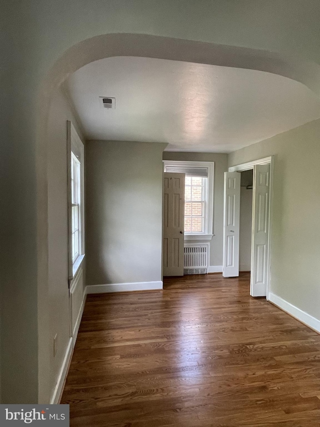 257 Jefferson St, Winchester, VA 22601 - spare room featuring radiator and dark wood-style floors
