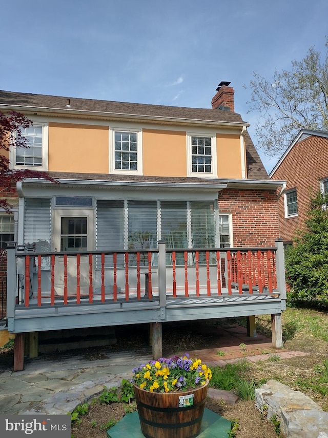 257 Jefferson St, Winchester, VA 22601 - back of house with a chimney, a wooden deck, and stucco siding