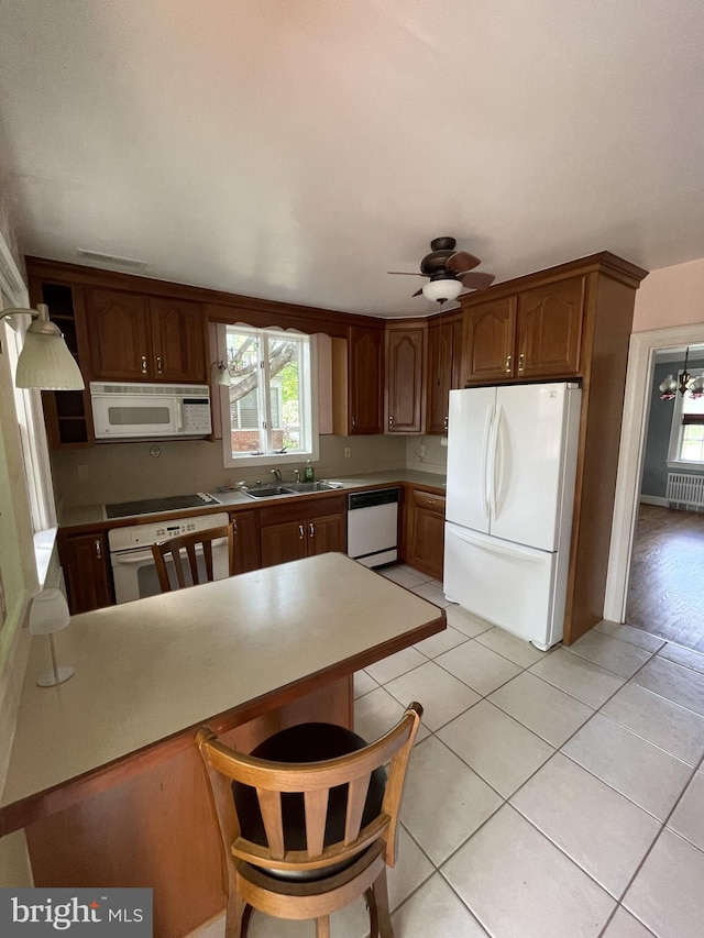 257 Jefferson St, Winchester, VA 22601 - kitchen with white appliances, a peninsula, ceiling fan, light tile patterned floors, and light countertops