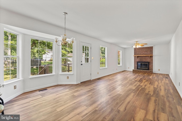 27 Brown Cir, Fredericksburg, VA 22405 - unfurnished living room with healthy amount of natural light, a chandelier, ceiling fan, and a fireplace