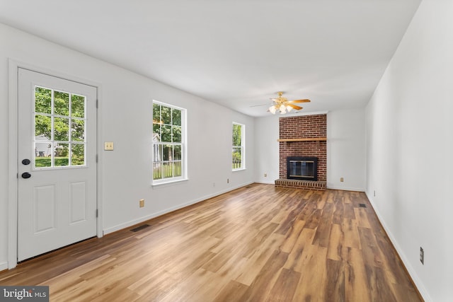 27 Brown Cir, Fredericksburg, VA 22405 - unfurnished living room featuring light wood-style flooring, a brick fireplace, and a ceiling fan
