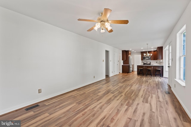 27 Brown Cir, Fredericksburg, VA 22405 - unfurnished living room with light wood-type flooring, a chandelier, a ceiling fan, and recessed lighting