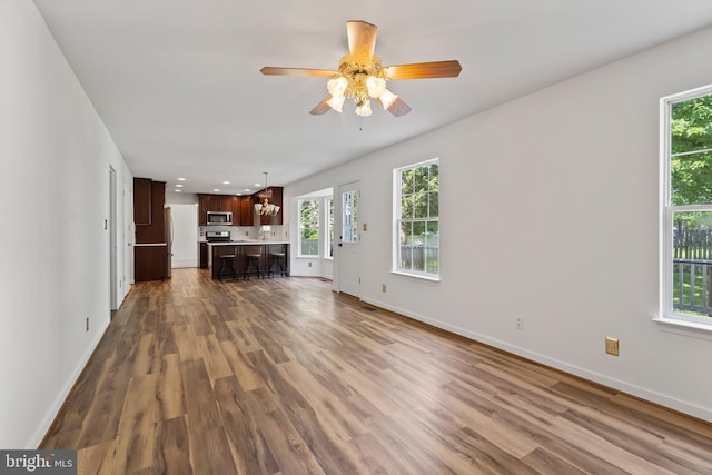 27 Brown Cir, Fredericksburg, VA 22405 - unfurnished living room featuring dark wood-type flooring, healthy amount of natural light, ceiling fan, and recessed lighting