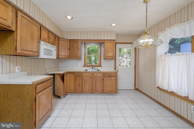 26 Rose Ln, Cherry Hill, NJ 08002 - kitchen with wallpapered walls, white microwave, a textured ceiling, light countertops, and a chandelier