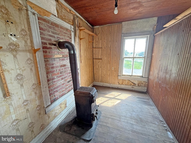 505 Battlefield Ft, Defiance, VA 24437 - unfurnished living room featuring a wood stove, hardwood / wood-style flooring, wood ceiling, and wood walls