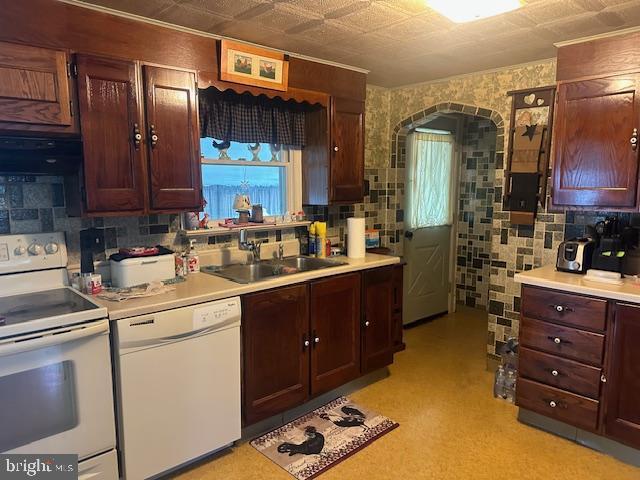 2012 E Main St, Douglassville, PA 19518 - kitchen with white appliances, arched walkways, light countertops, and healthy amount of natural light