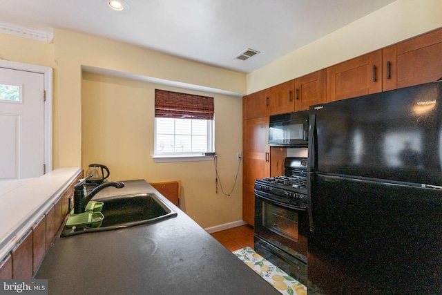 6221 Sandpiper Ct Unit 7, Elkridge, MD 21075 - kitchen with black appliances, brown cabinetry, light tile patterned floors, and recessed lighting