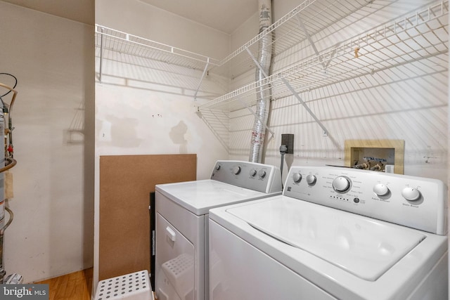 6221 Sandpiper Ct Unit 7, Elkridge, MD 21075 - laundry room featuring washer and dryer and wood finished floors