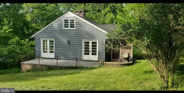 769 S Water St, Woodstock, VA 22664 - back of property featuring a lawn, a chimney, a patio area, and french doors