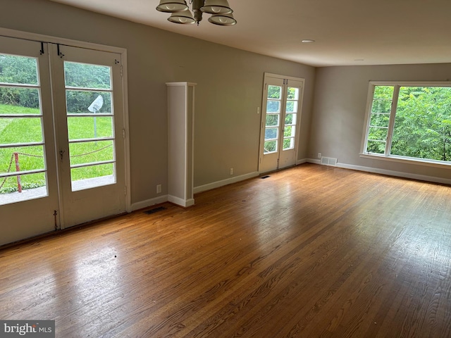 769 S Water St, Woodstock, VA 22664 - empty room featuring a chandelier, wood finished floors, and french doors