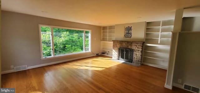 769 S Water St, Woodstock, VA 22664 - unfurnished living room featuring wood finished floors, a fireplace, and built in shelves